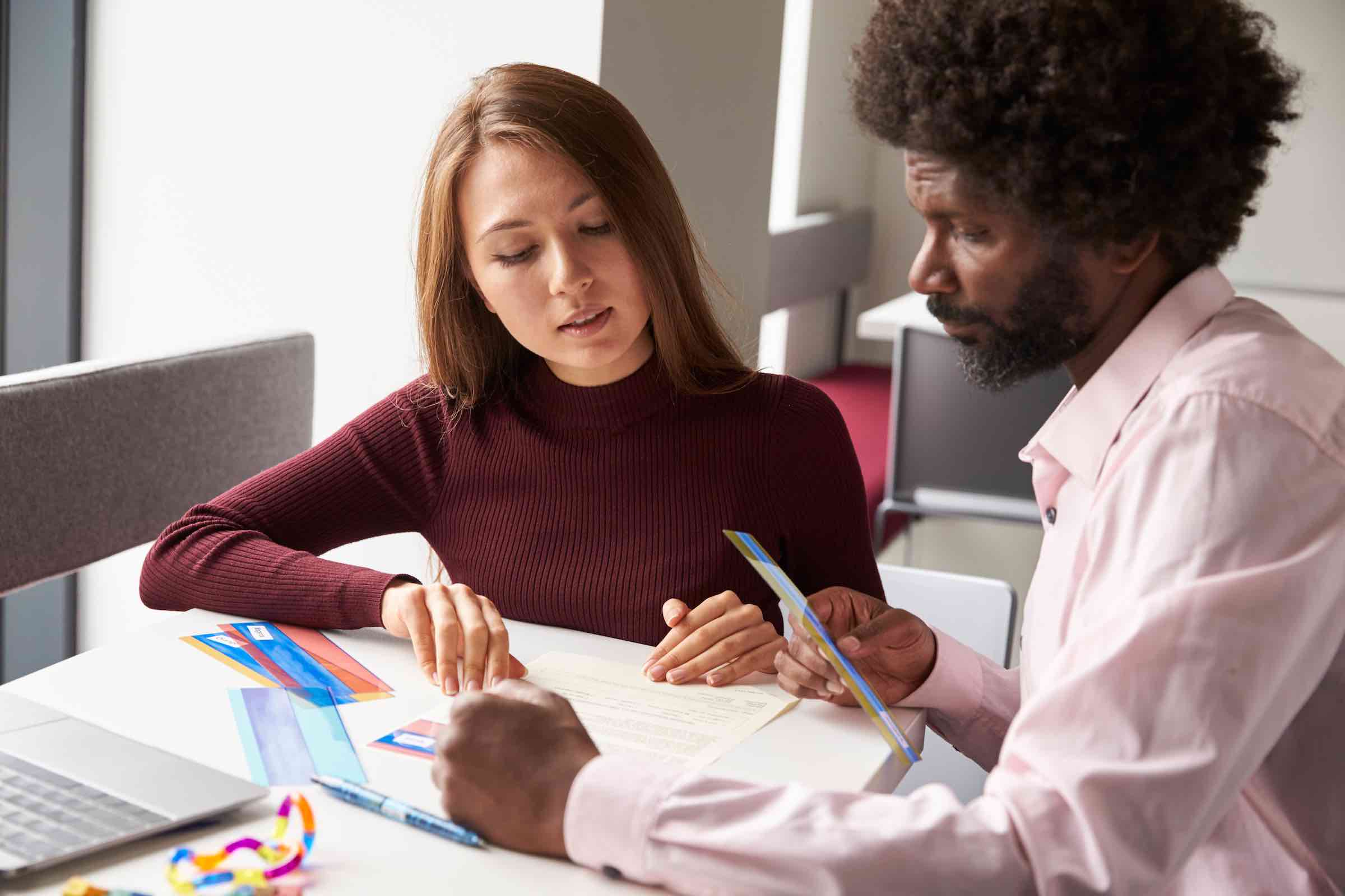 Male teacher working on reading with female student
