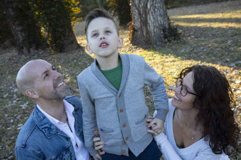 picture of Abby and her husband looking up at their son.