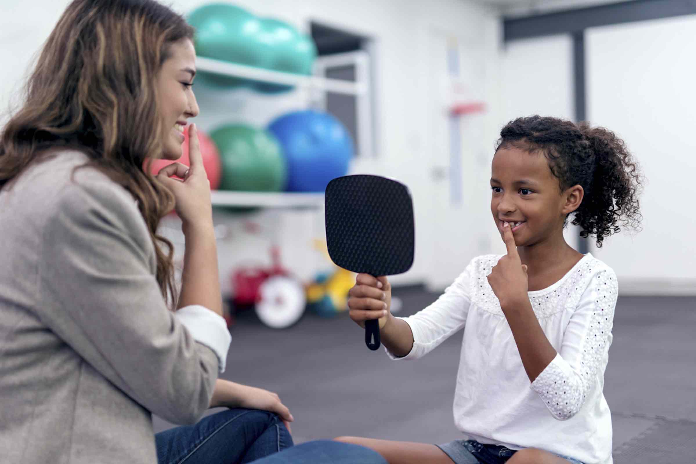 speech therapist working with child on sounds