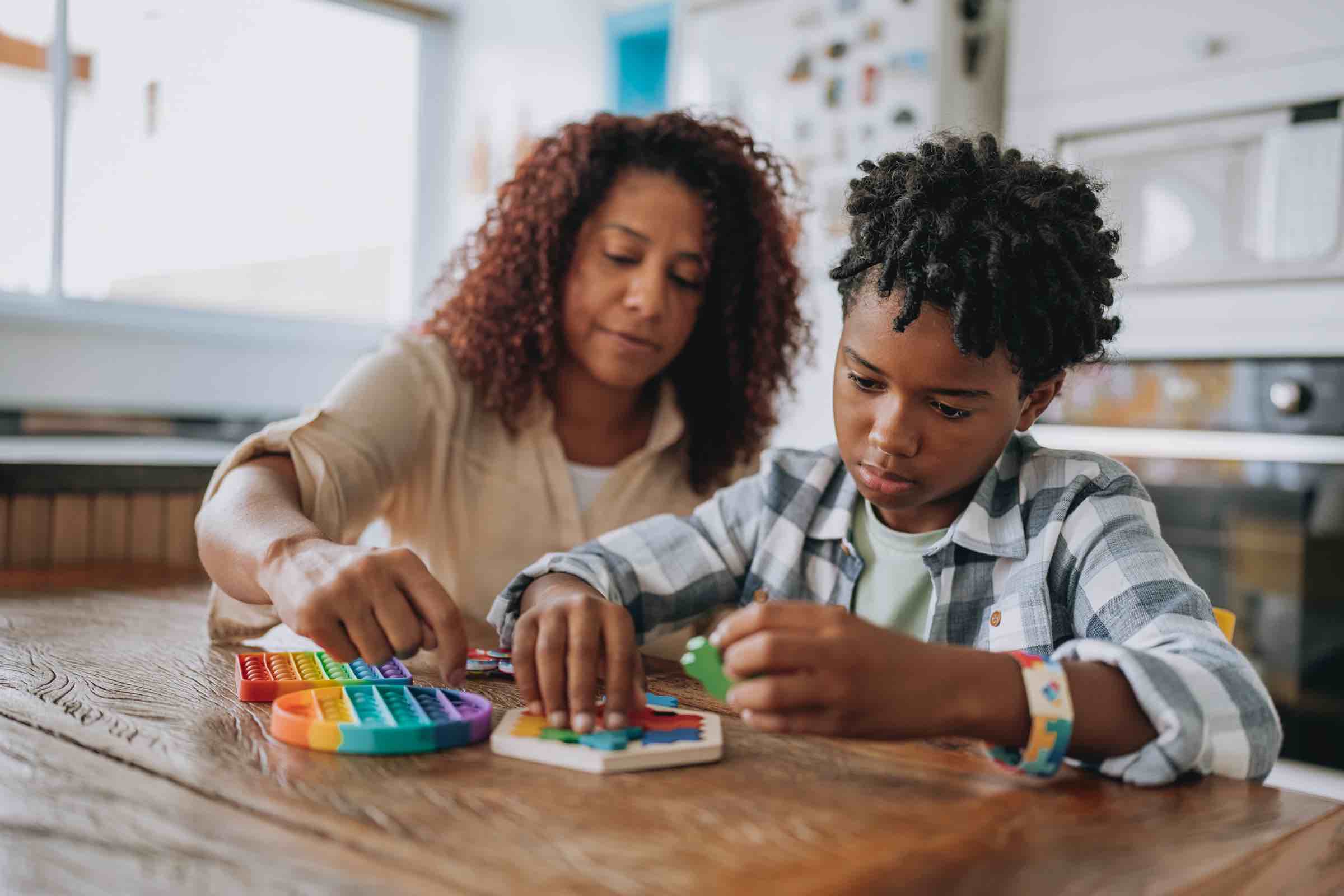 Mother playing with autistic son