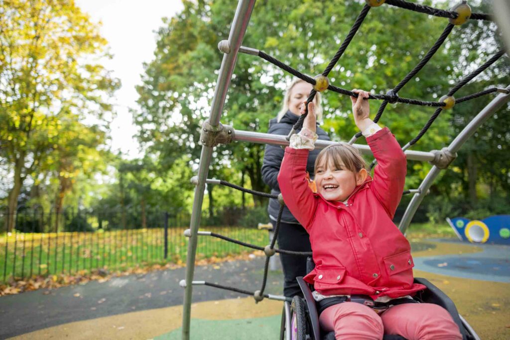 child playing with parent at the park