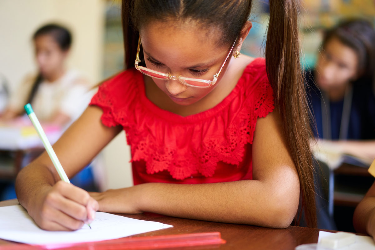 Girl taking test in classroom