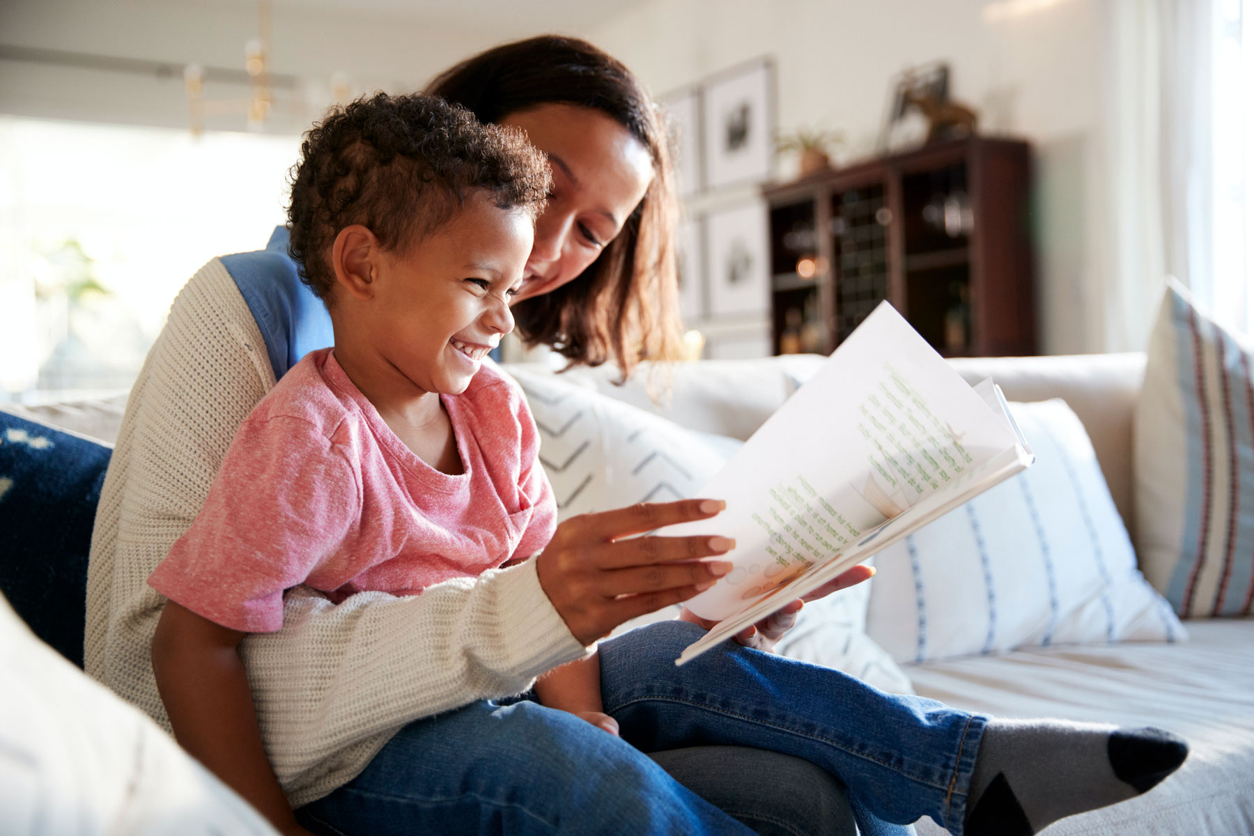 Mother reading with child, smiling