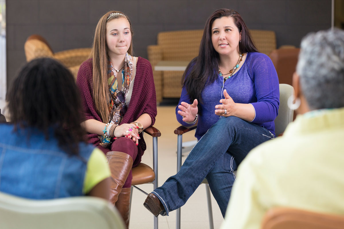 mother and daughter in meeting, mother explaining