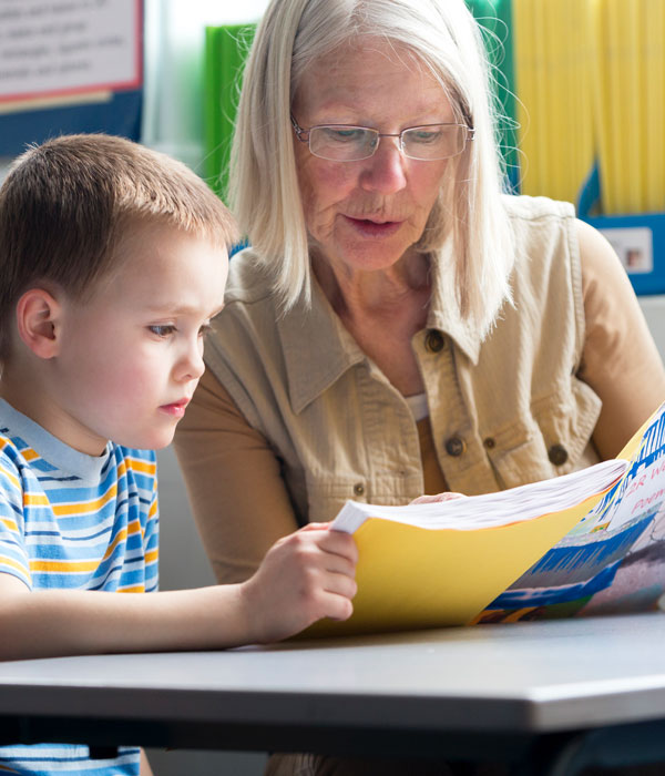 image of teacher reading to young boy