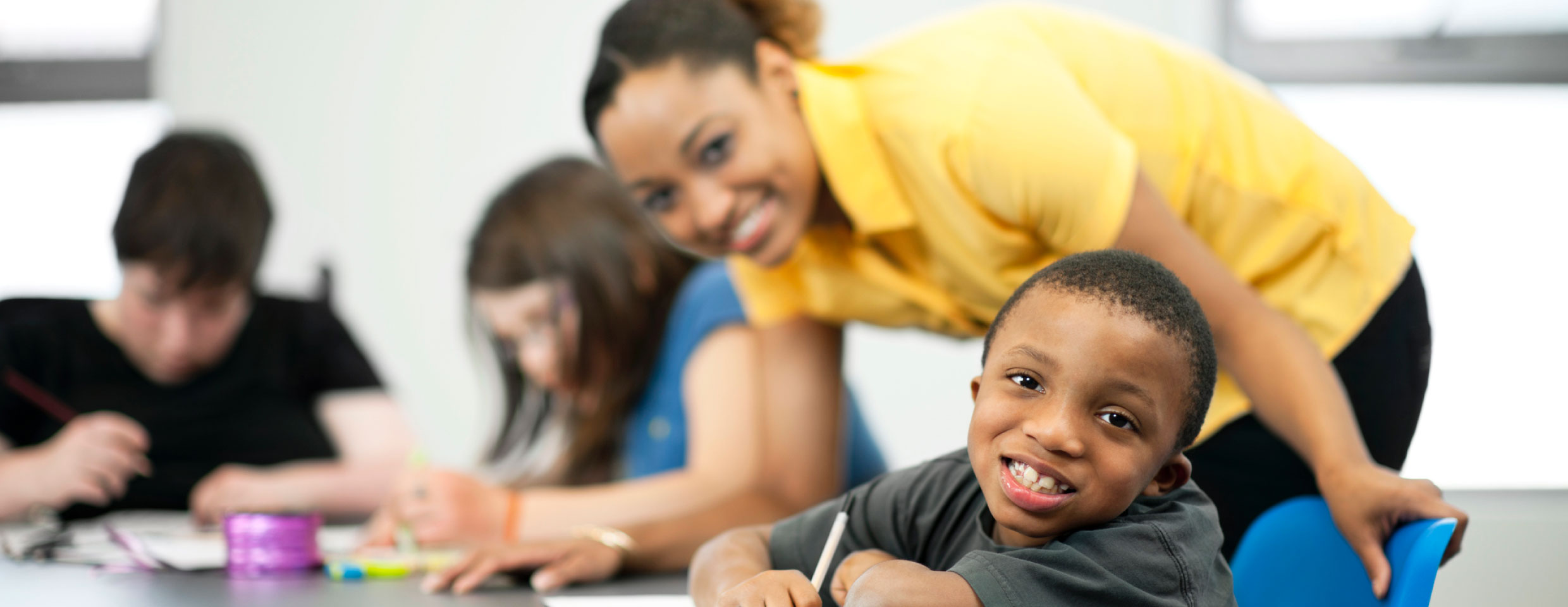 child at school with teacher, smiling