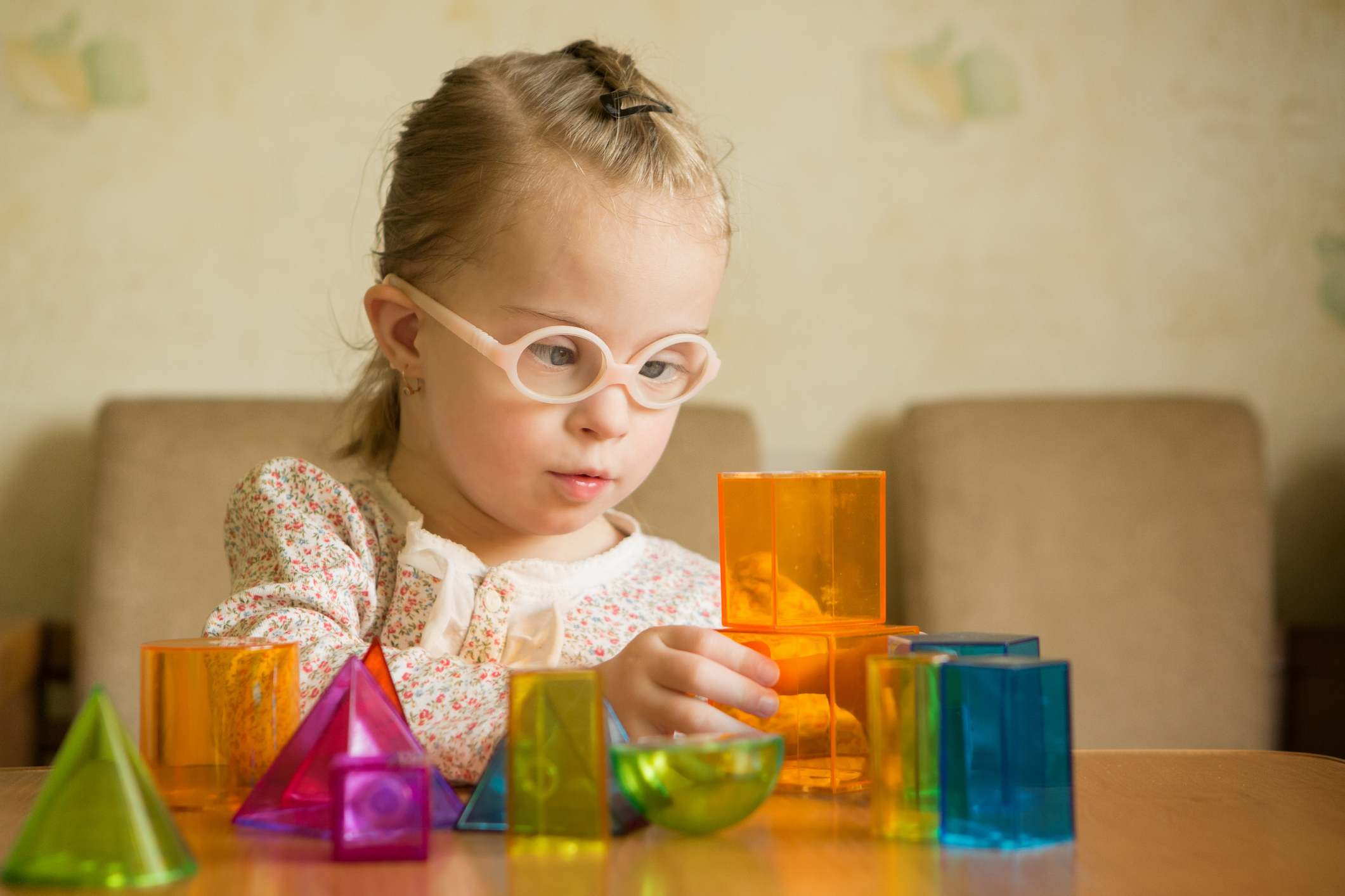 Girl with Down syndrome playing with geometrical shapes