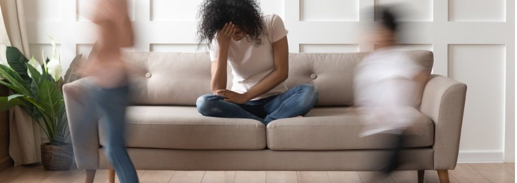 image of frustrated mom with her head down while blurred out kids run around with text that says WEBINAR, Children's Behavior: The tough part of parenting