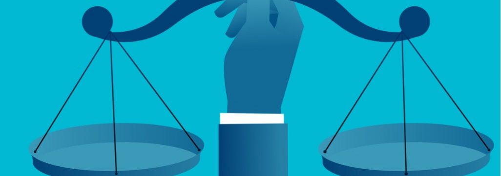 hand holding a balance scale in various shades of blue