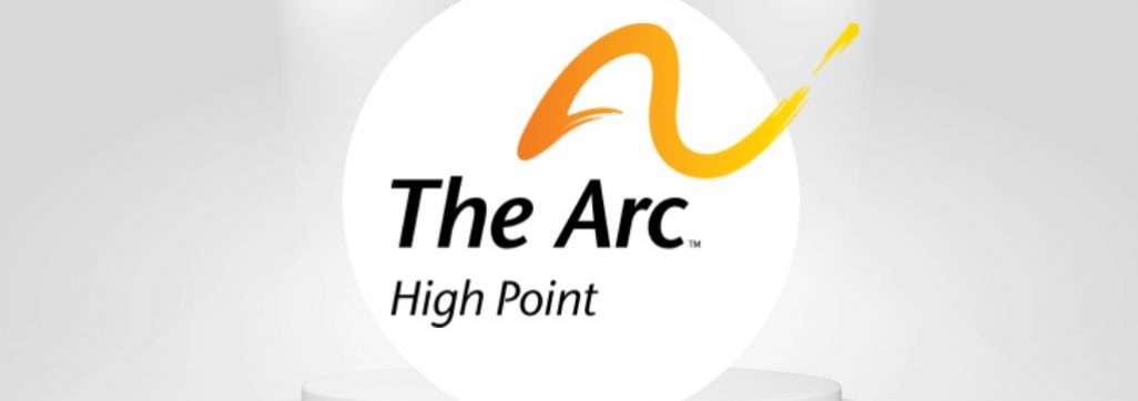 Image of stage with lights shining on The Arc of High Point