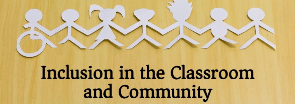 white paper cut outs of children holding hands on a wooden background
