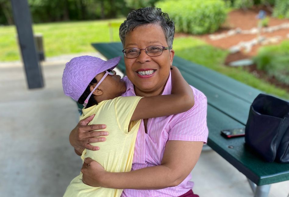 ECAC employee at the zoo with a child that attended the event.